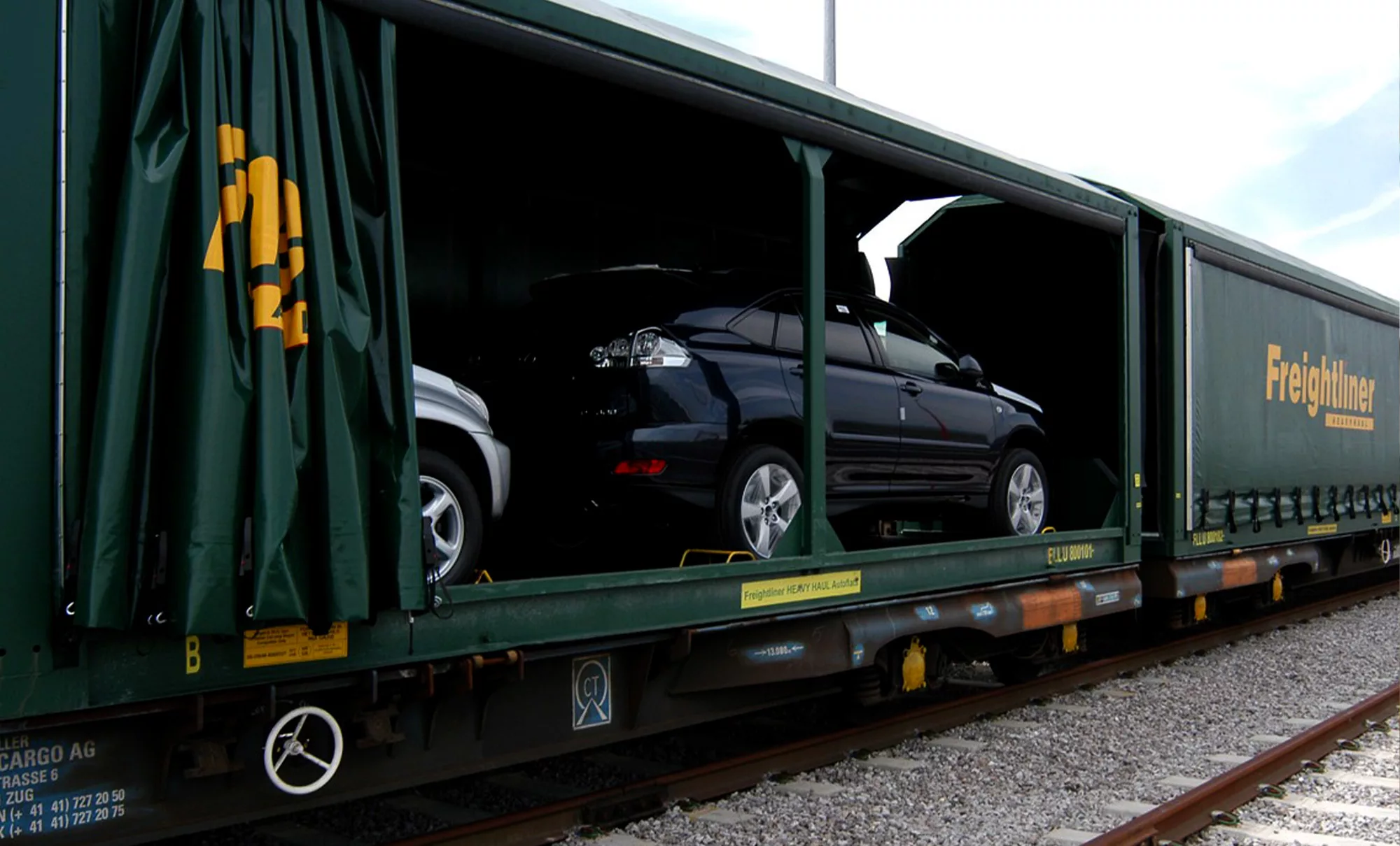 Automobiles being transported by Freightliner Heavy Haul solutions.