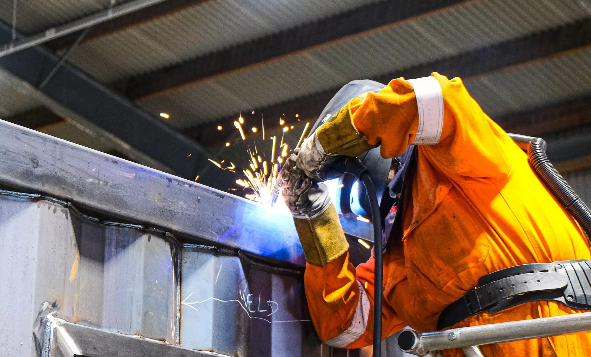 Freightliner employee repairing container in Freightliner workshop.