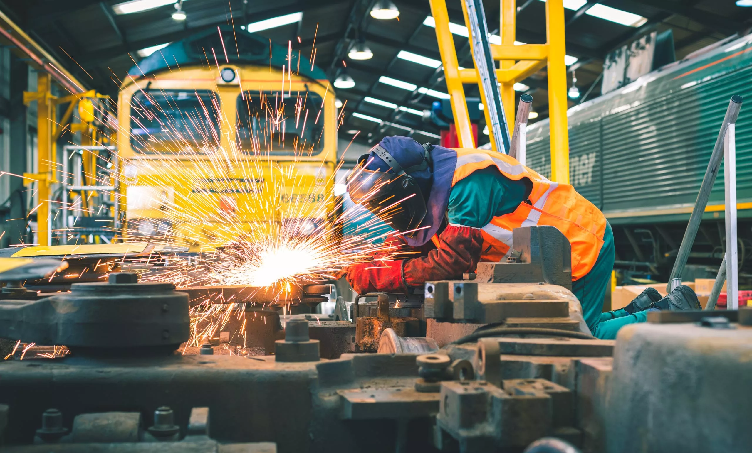 Freightliner employee welding Freightliner loco parts.